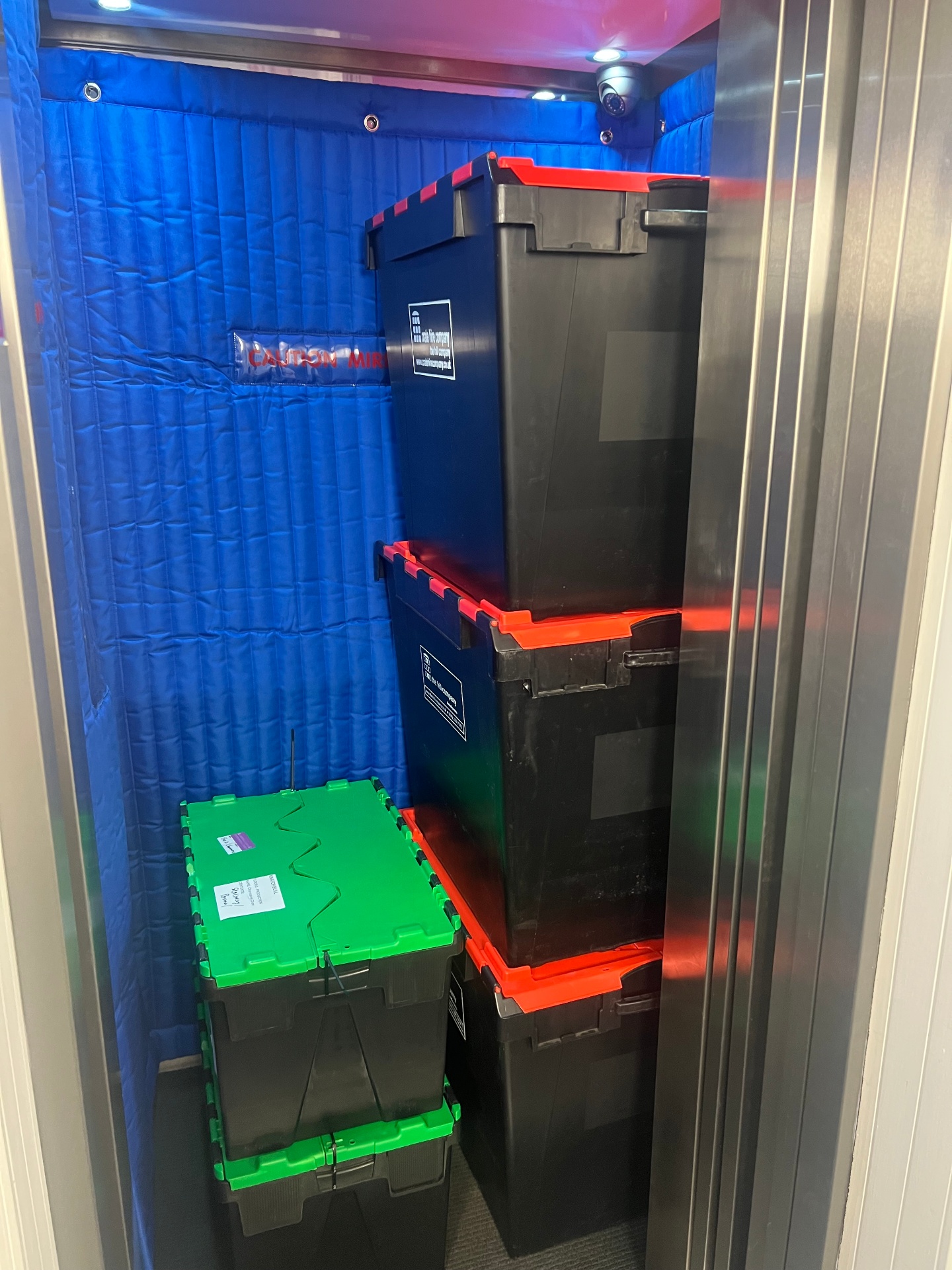 Lift crates stacked inside a residential lift during a flat move